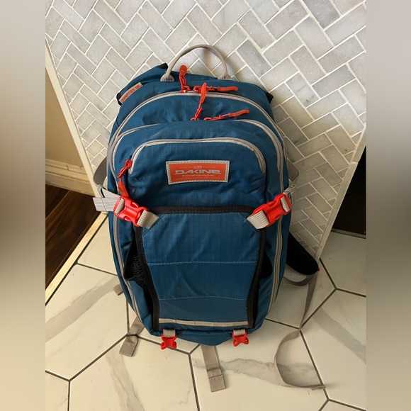 Dakine Teal Backpack with Orange Accents. Cycling backpack with room for helmet